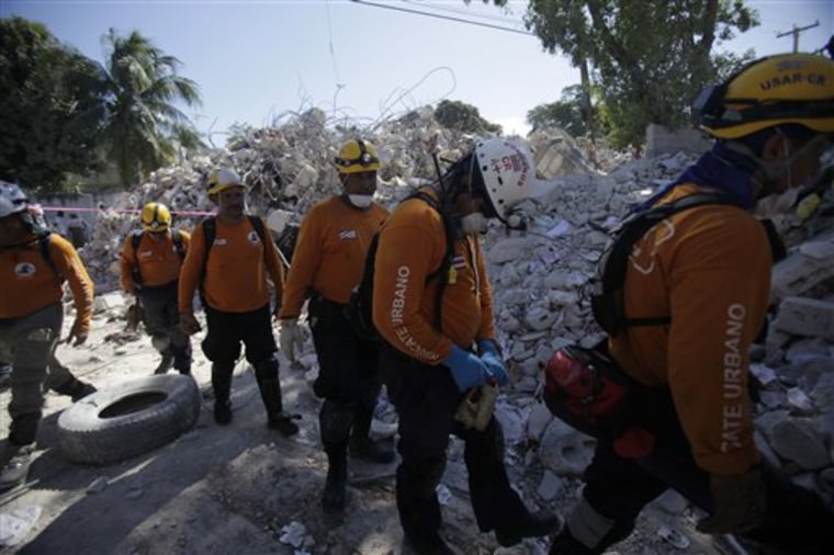 A rescue team from Costa Rica leaves a site after signs of life were no longer found among the debris in Port-au-Prince, Thursday, Jan. 21, 2010. A powerful earthquake hit Haiti on Jan. 12. 